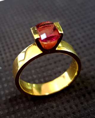 9k gold ring set with a precision cut Rhodolite Garnet