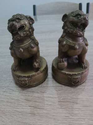 A pair of chinese bronze foo dogs on circular bases mark to base
