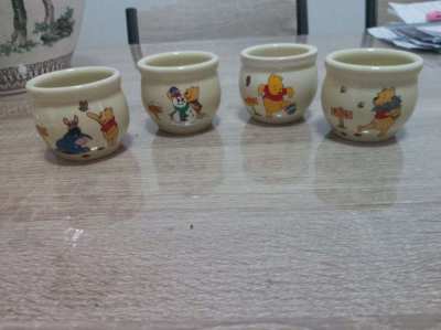 A set of 4 highly collectable Disney winnie the pooh honey pots