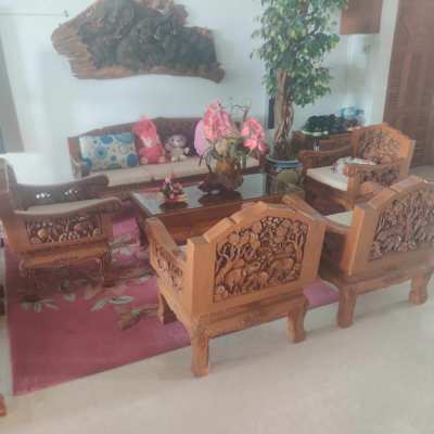 4 arm chairs and a solid teak sofa and table