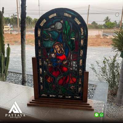 Antique stained glass Virgin Mary on woodenstand
